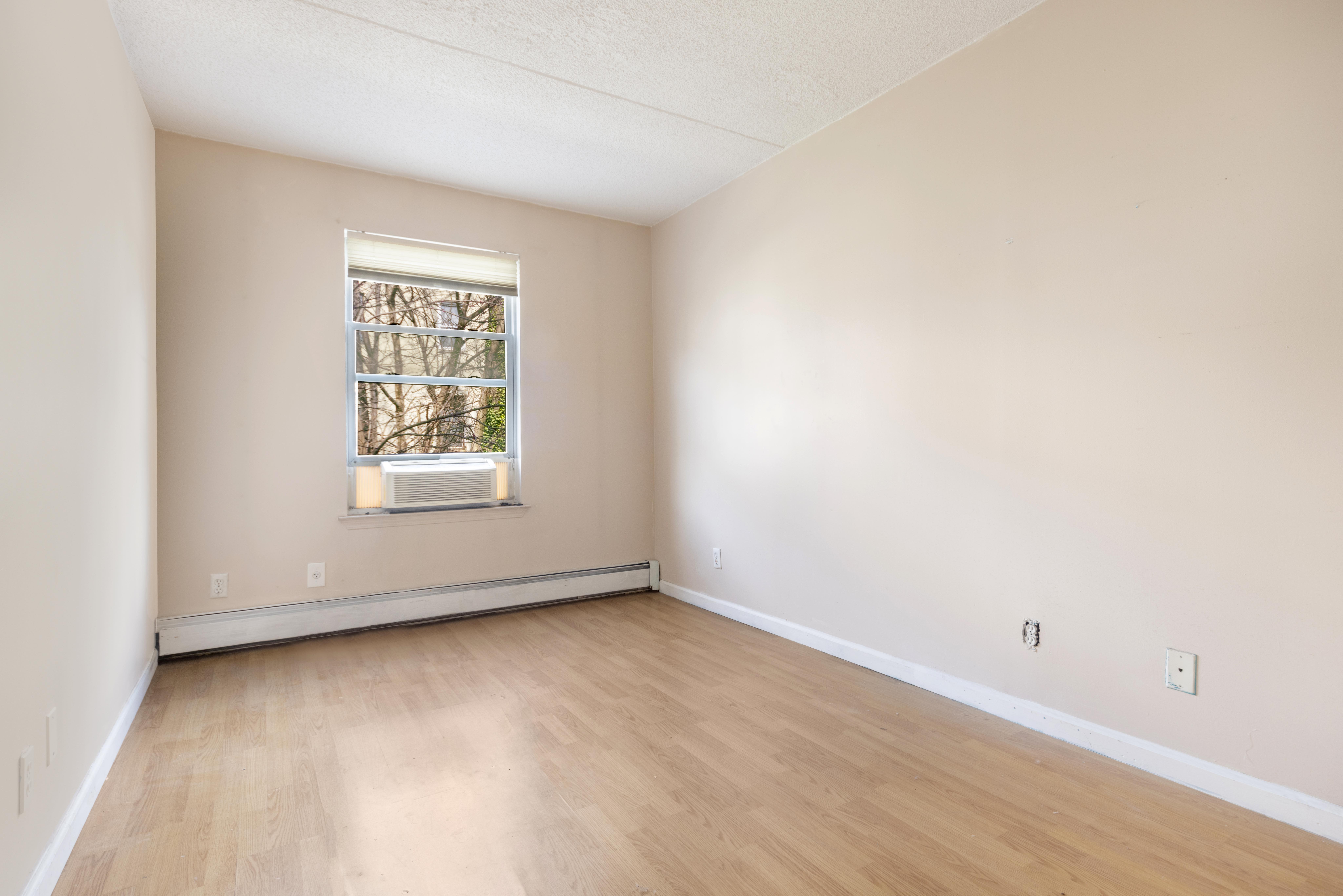125 West 117th Street Manhattan, NY 10026 - Photo 13 of 23 an empty room with a window