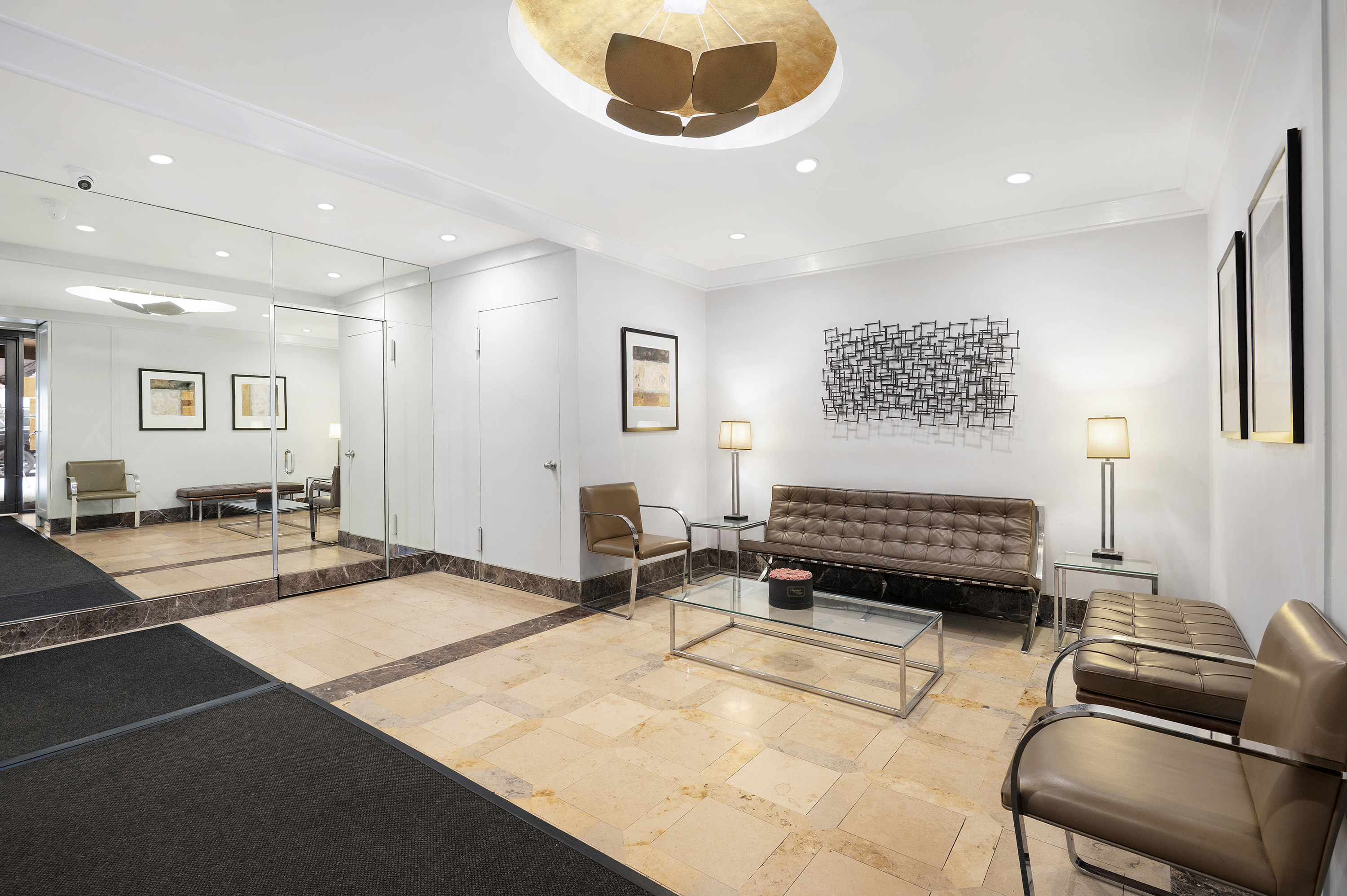 153 East 57th Street, Unit 8J Manhattan, NY 10022 - Photo 7 of 8 a bedroom with a bed and a couch