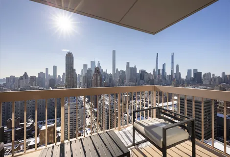 a view of a balcony with wooden benches