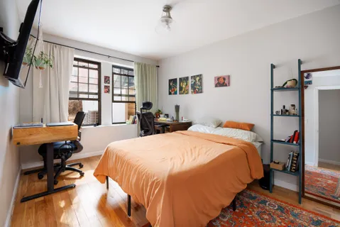 a bedroom with a bed a table and chair