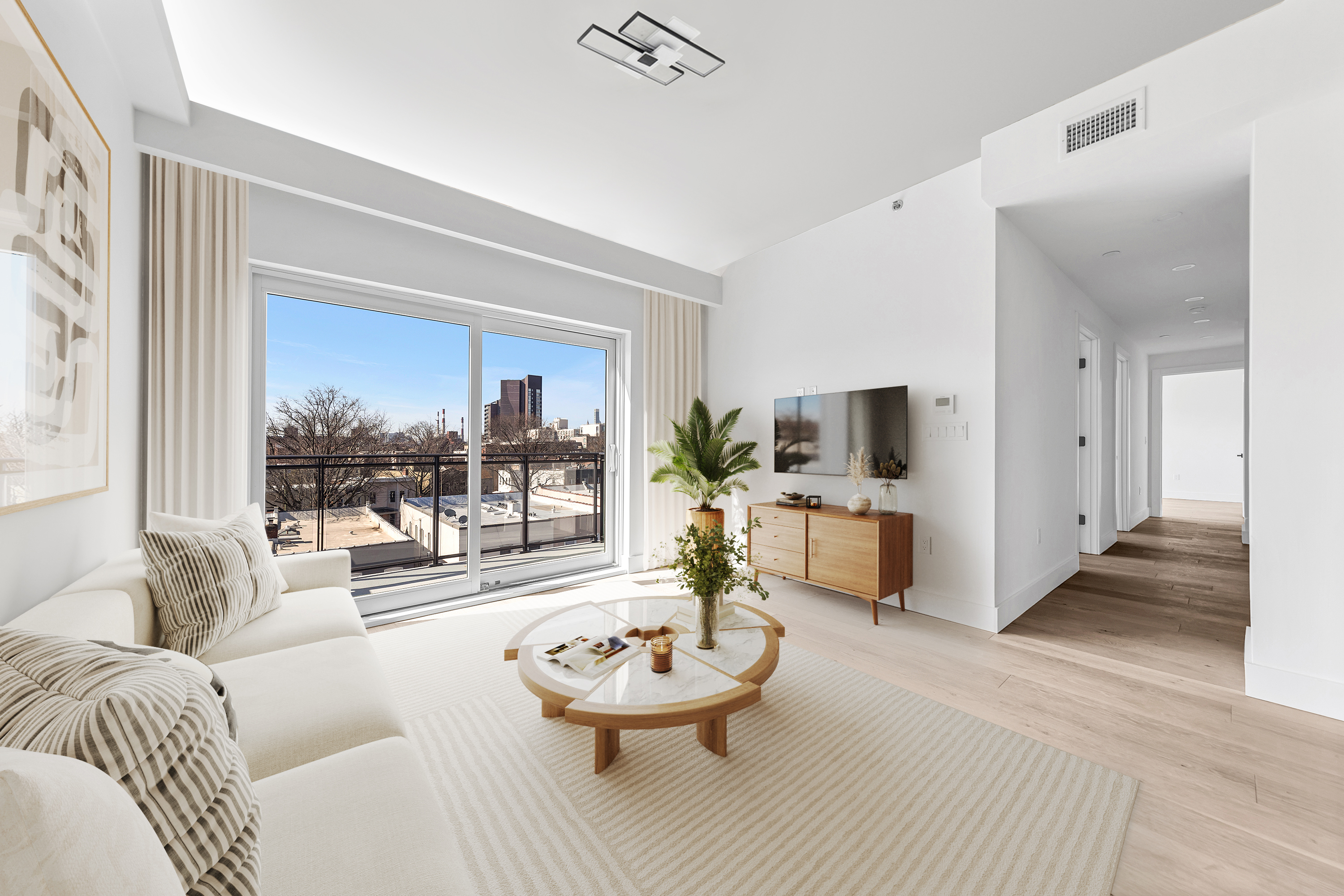 12-16 30th Avenue, Unit PH3 Queens, NY 11102 - Photo 1 of 19 a living room with furniture and a large window