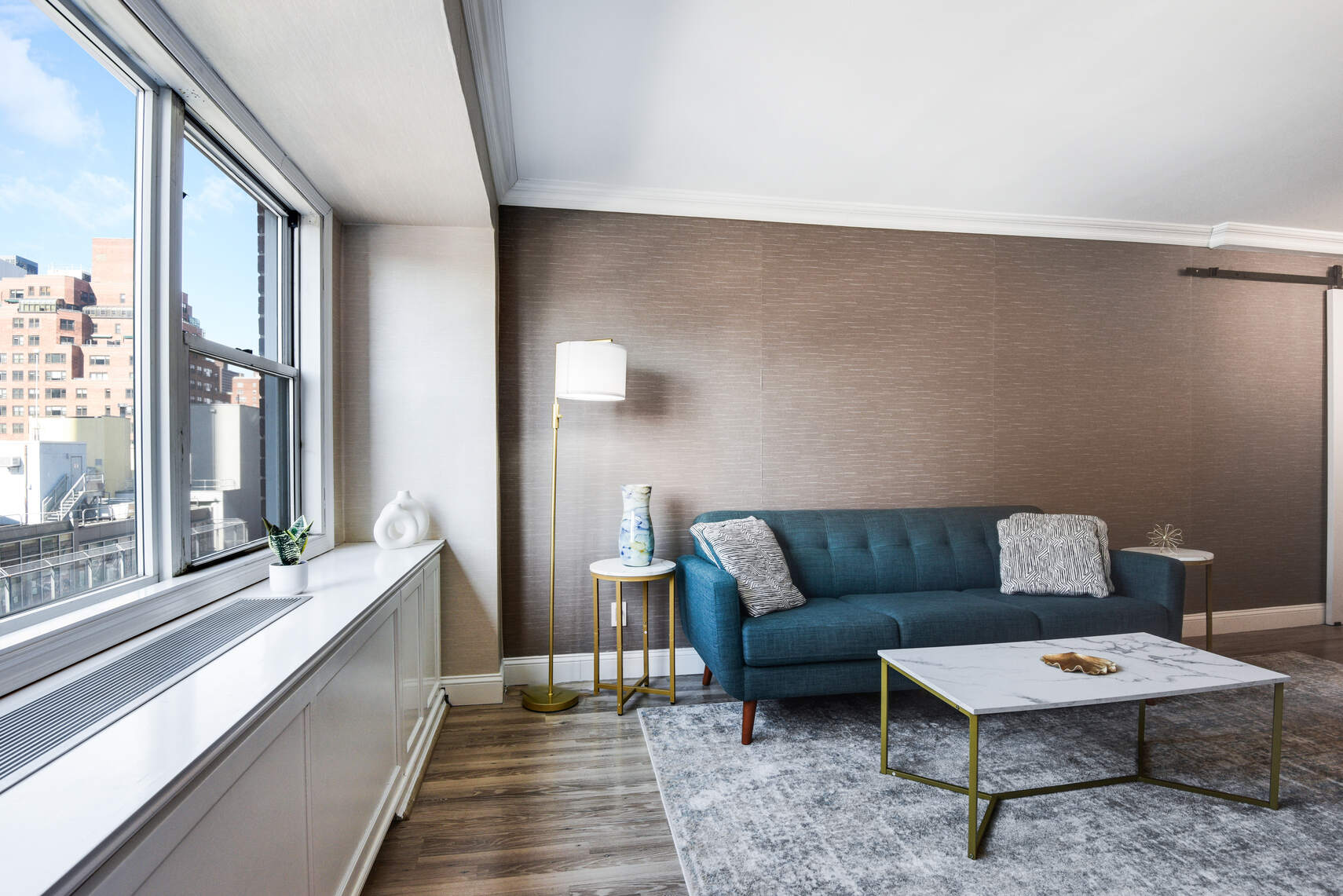 520 East 76th Street, Unit 11C Manhattan, NY 10021 - Photo 4 of 15 a living room with furniture and a large window