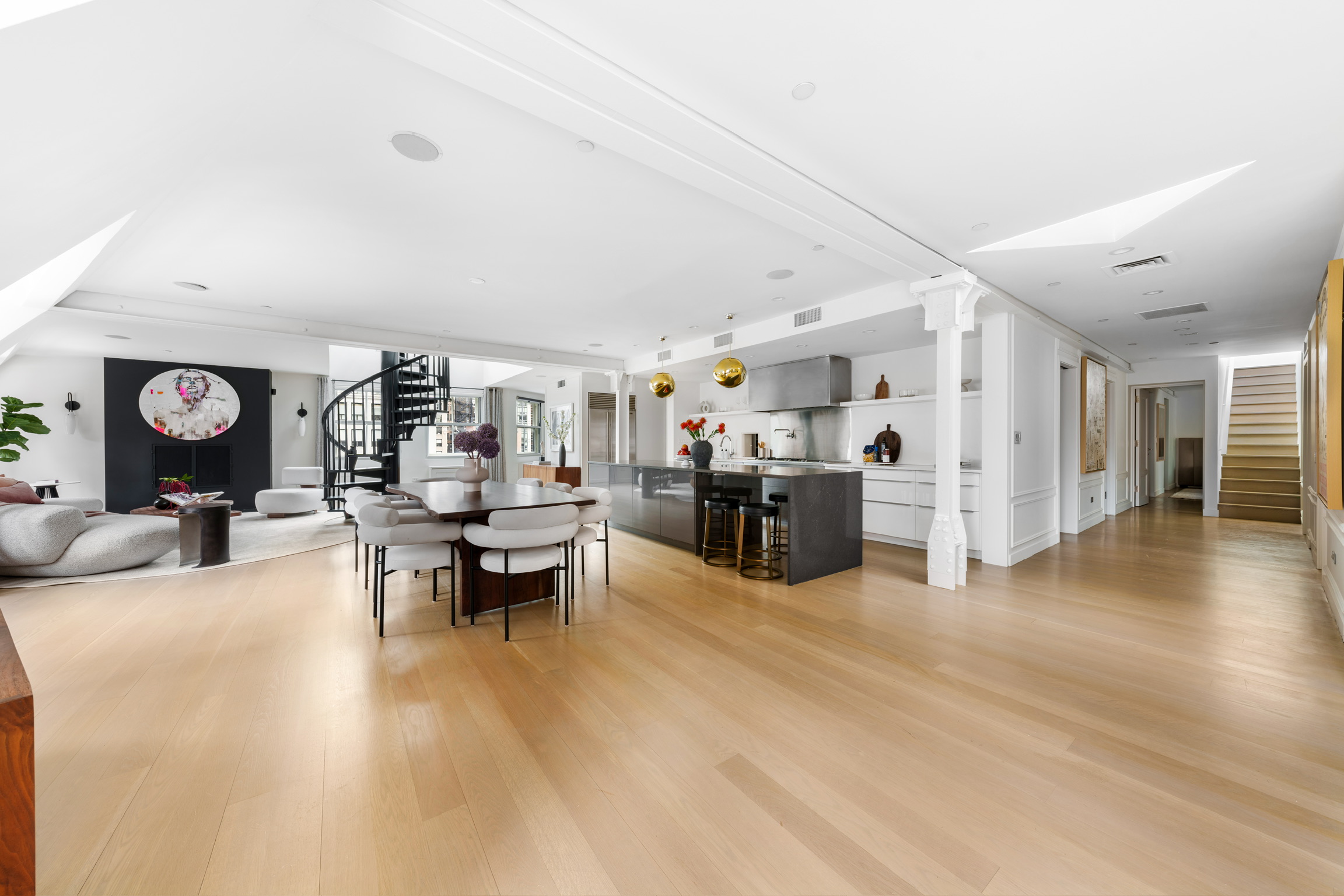 1200 Broadway, Unit PH89 Manhattan, NY 10001 - Photo 4 of 47 a living room with furniture and a dining table with wooden floor