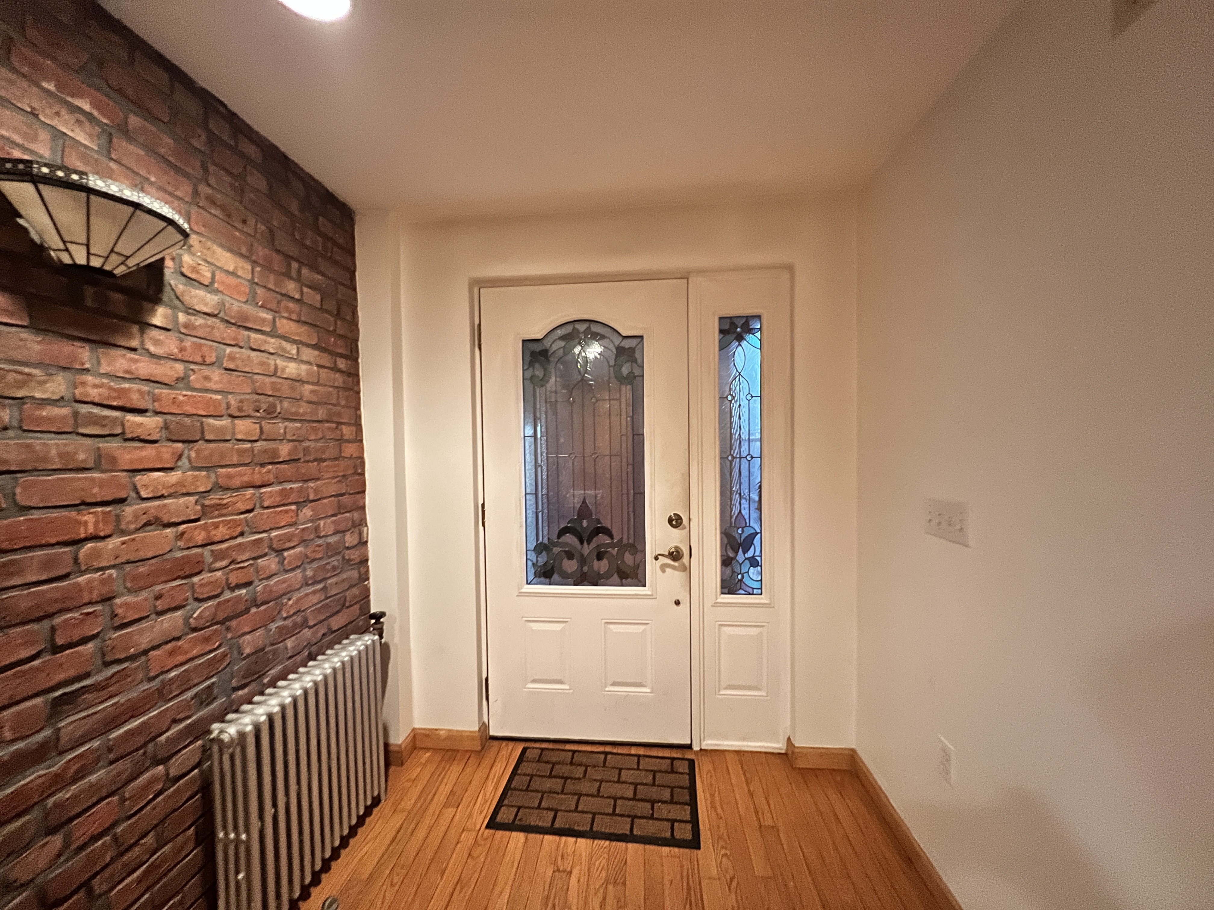 75 Warren Street, Unit 1 Brooklyn, NY 11201 - Photo 9 of 14 a view of a balcony with wooden floor and a window