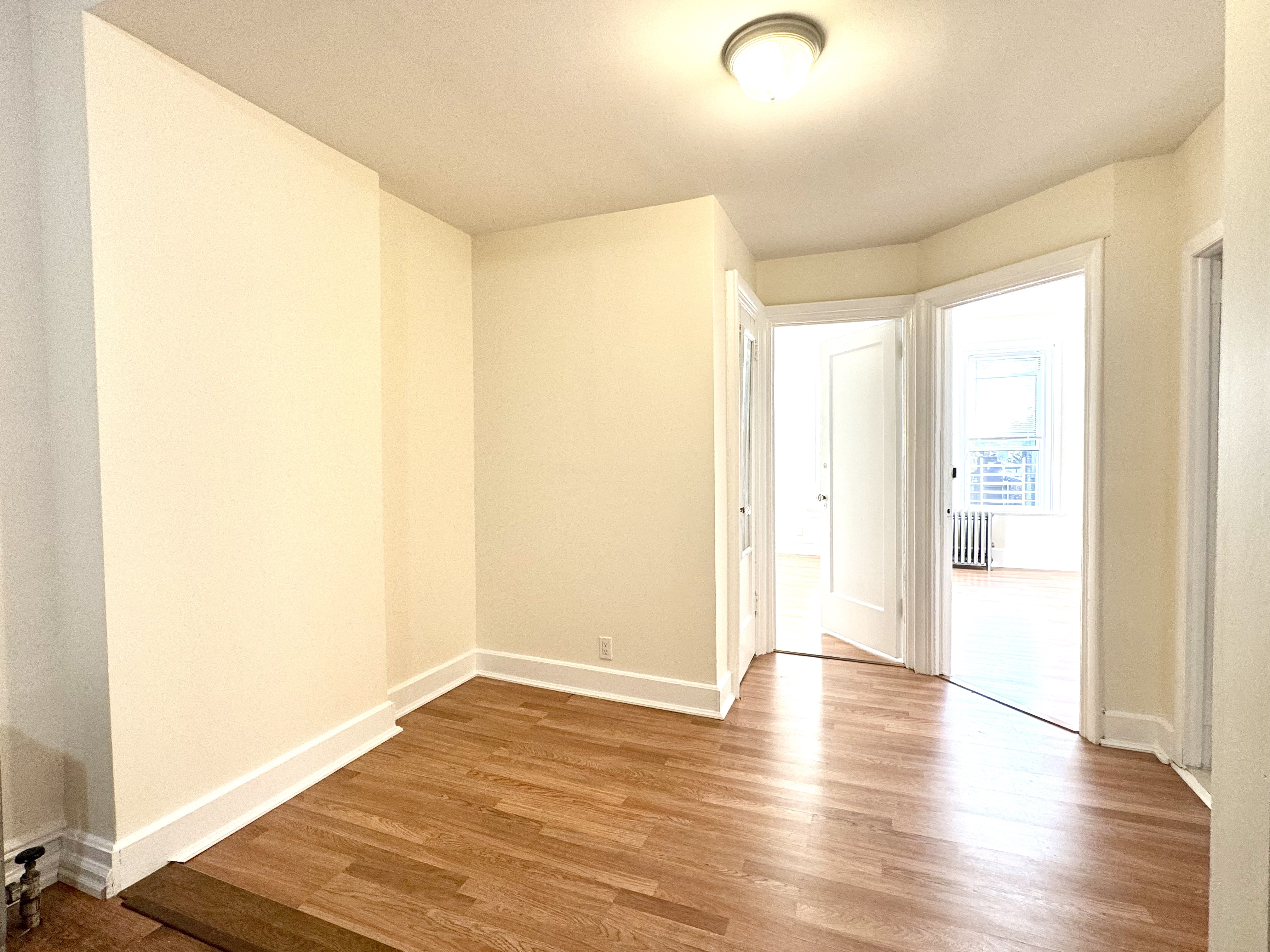 1688 Carroll Street, Unit 2 Brooklyn, NY 11213 - Photo 4 of 9 a view of an empty room with wooden floor