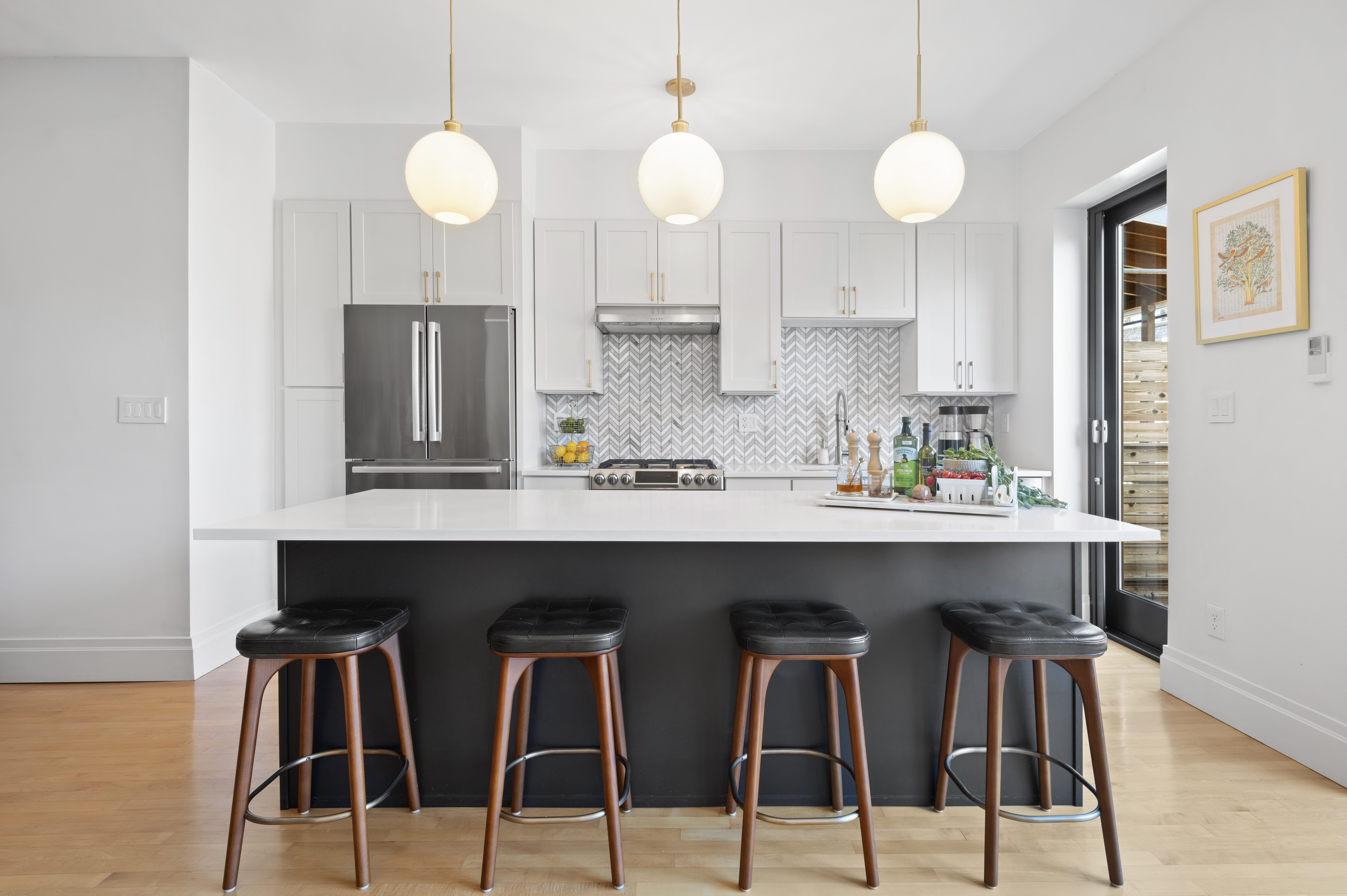 185 East 31st Street Brooklyn, NY 11226 - Photo 2 of 23 a kitchen with stainless steel appliances kitchen island a table and chair in it