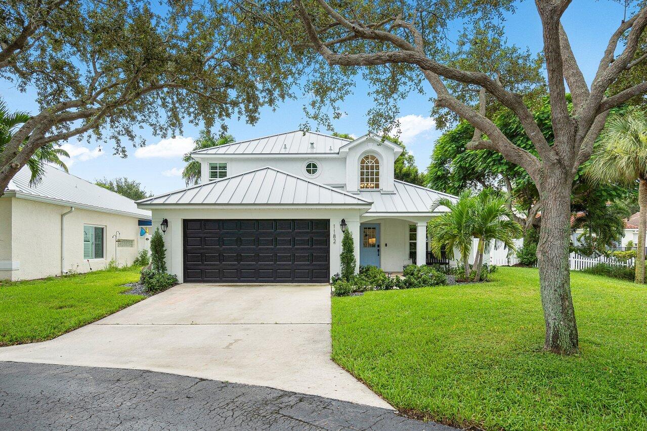 1182 Canoe Point Delray Beach, FL 33444 - Photo 1 of 46 a front view of a house with yard