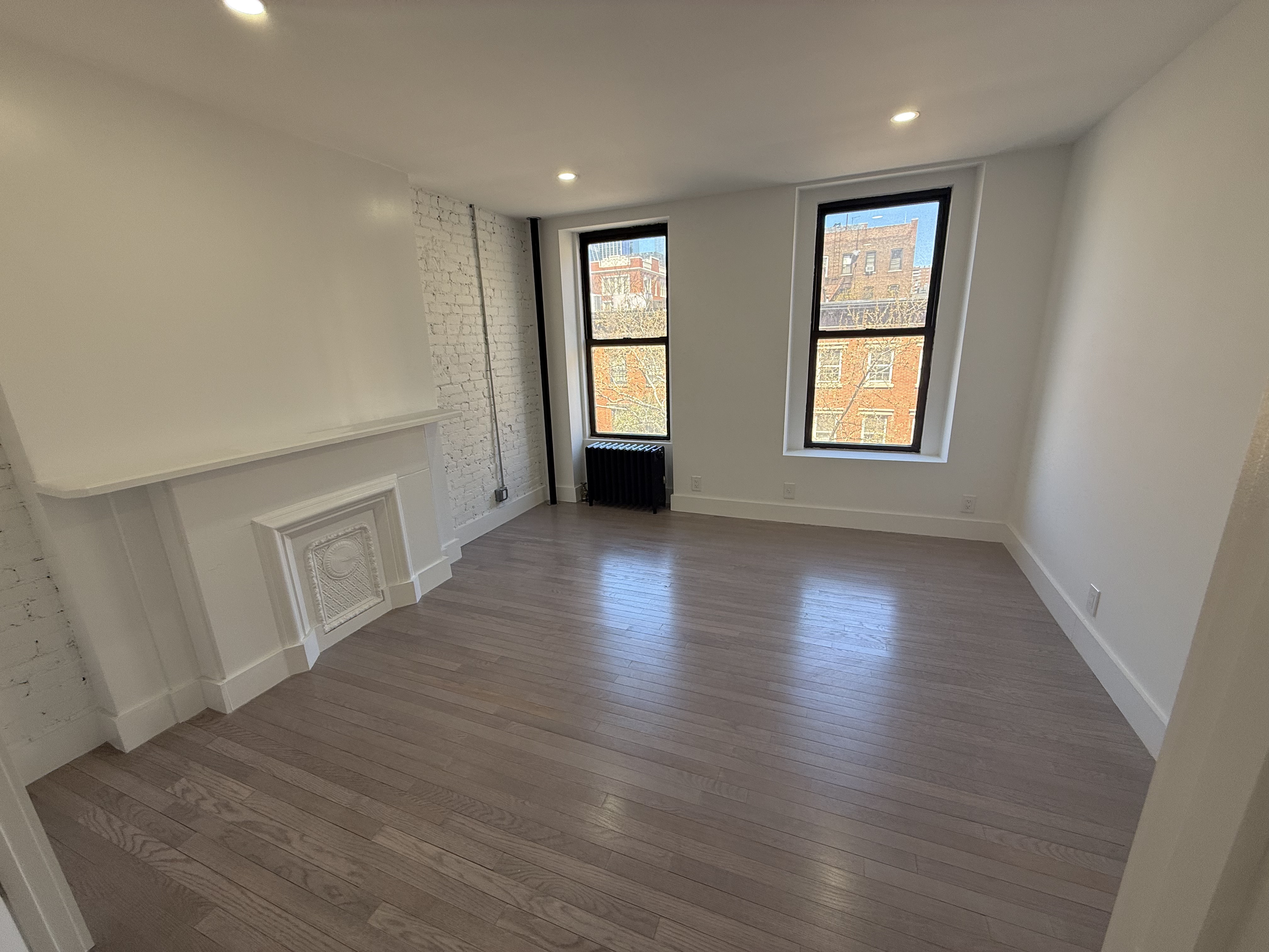 316 West 19th Street, Unit 4W Manhattan, NY 10011 - Photo 1 of 7 an empty room with wooden floor and windows