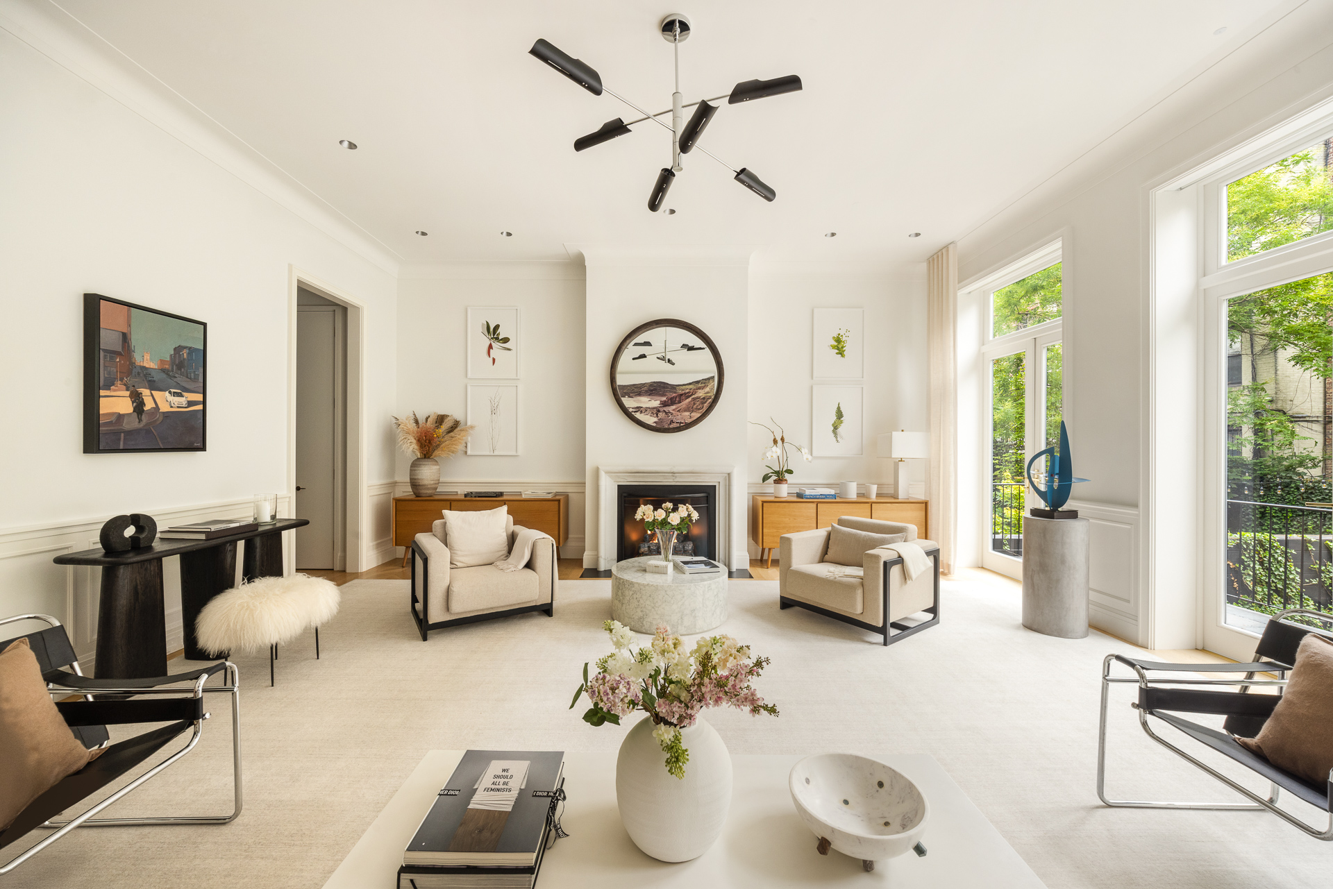 a living room with furniture a clock and a large window