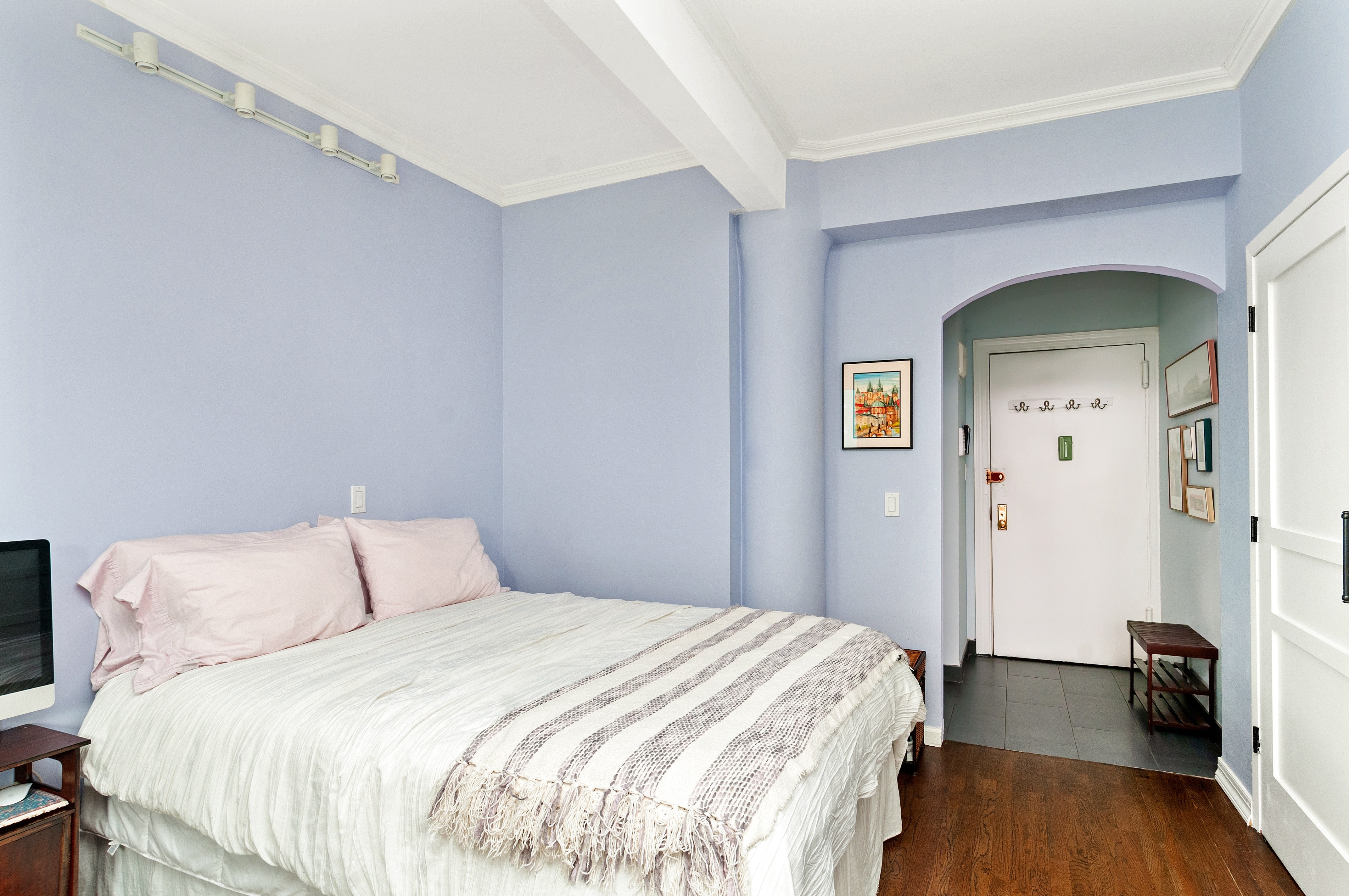 10 Christopher Street, Unit 4B Manhattan, NY 10014 - Photo 2 of 6 a bedroom with a bed and wooden floor