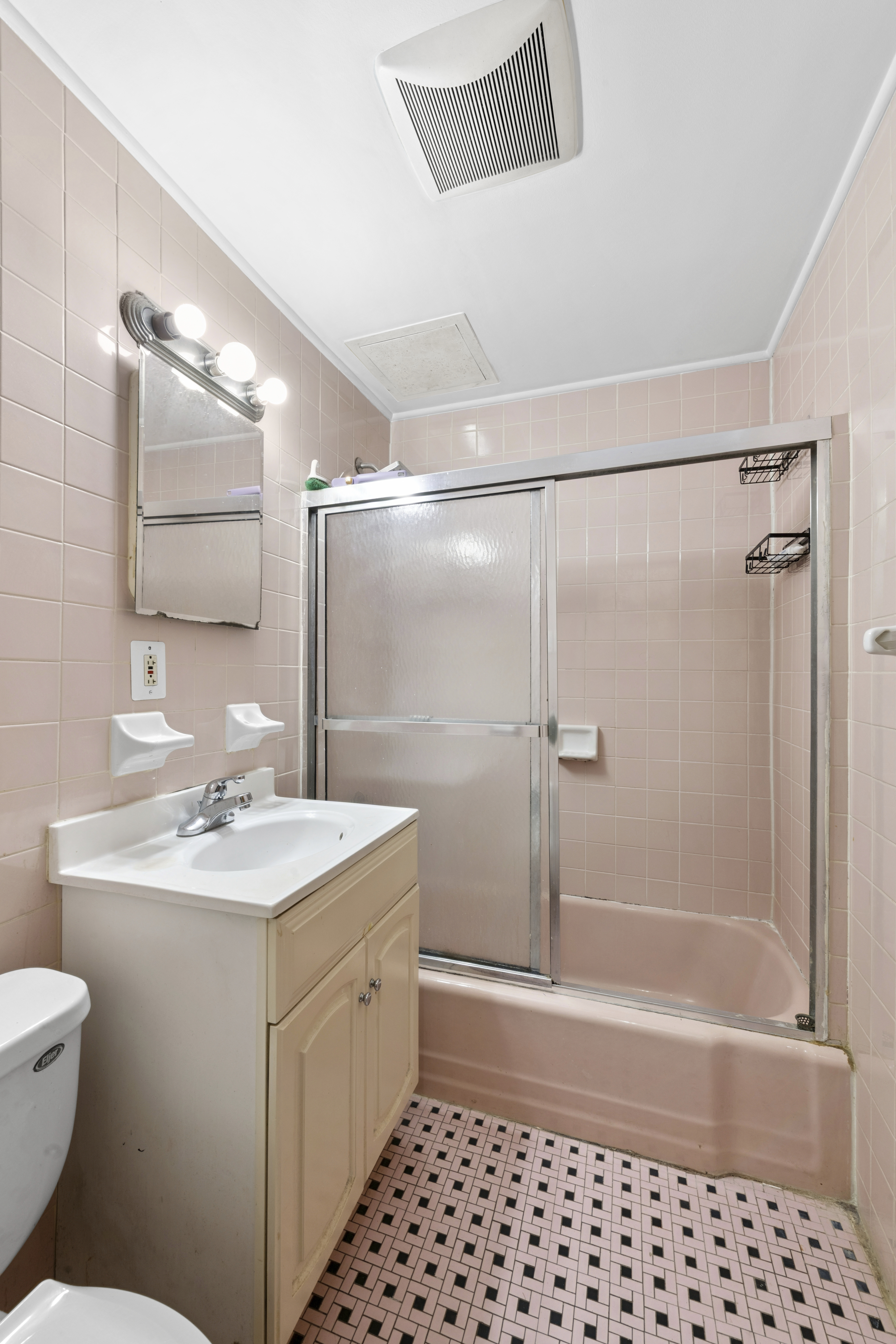 25-36 72nd Street Queens, NY 11370 - Photo 12 of 17 a bathroom with a sink a toilet and shower