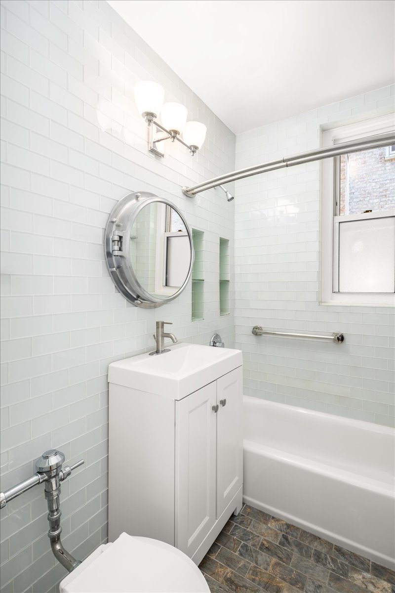 360 Clinton Avenue, Unit 1D Brooklyn, NY 11238 - Photo 11 of 17 a bathroom with a sink a toilet and bathtub