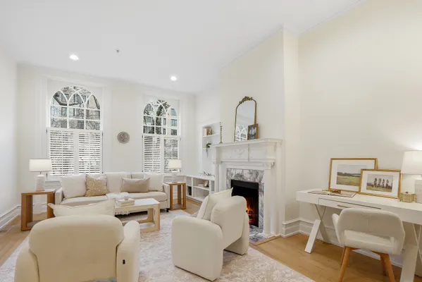 a living room with furniture a fireplace and a table