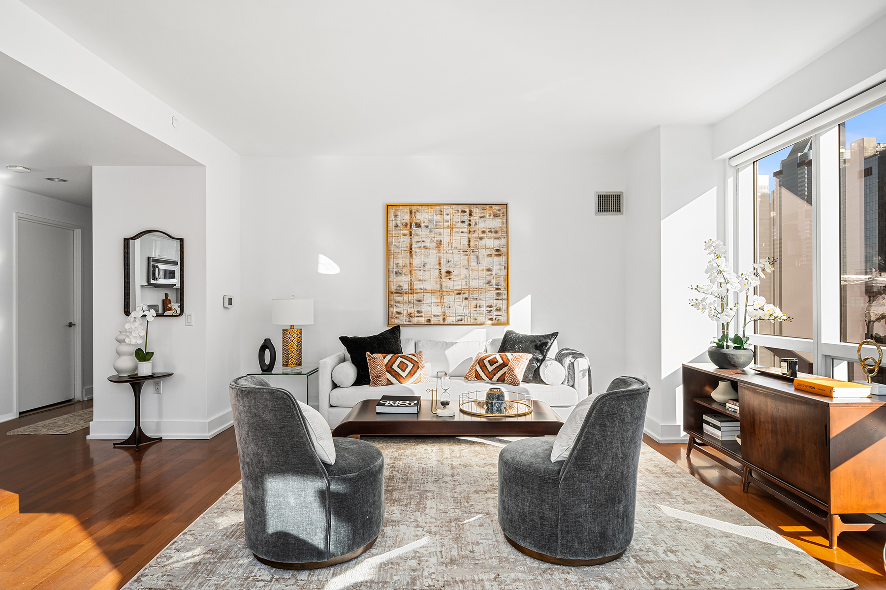 a living room with fireplace furniture and a large window