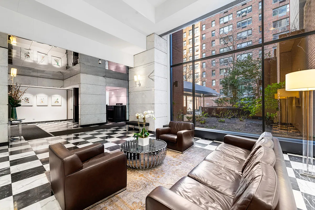 300 East 62nd Street, Unit 1001 Manhattan, NY 10065 - Photo 8 of 10 a living room with furniture and a flat screen tv