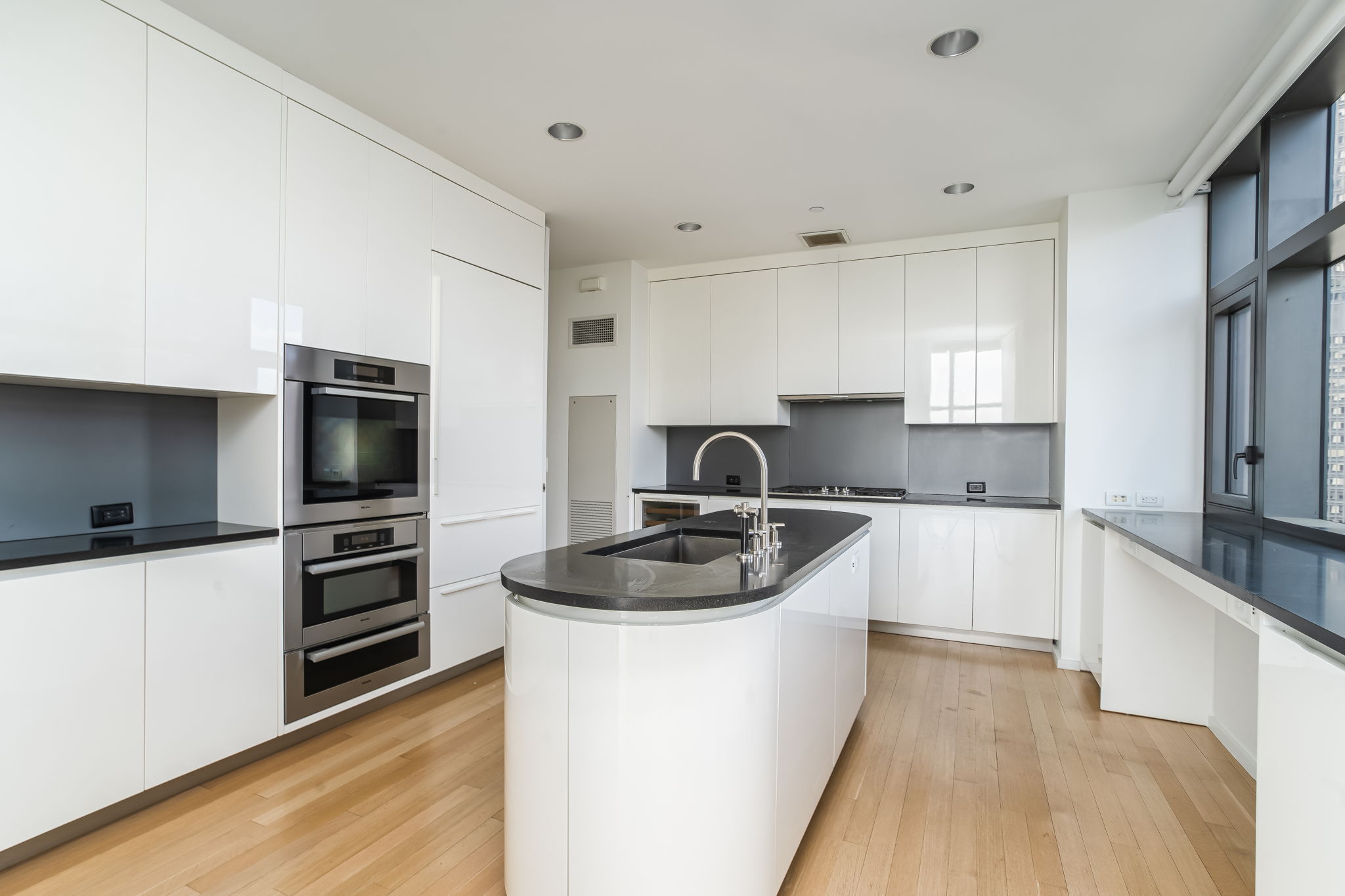 50 United Nations Plaza, Unit 26B Manhattan, NY 10017 - Photo 12 of 25 a kitchen with a sink stove and refrigerator