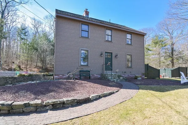 a view of a house with yard and tree s