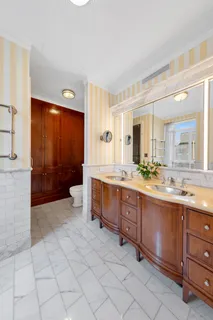 a spacious bathroom with a sink a mirror and a bathtub