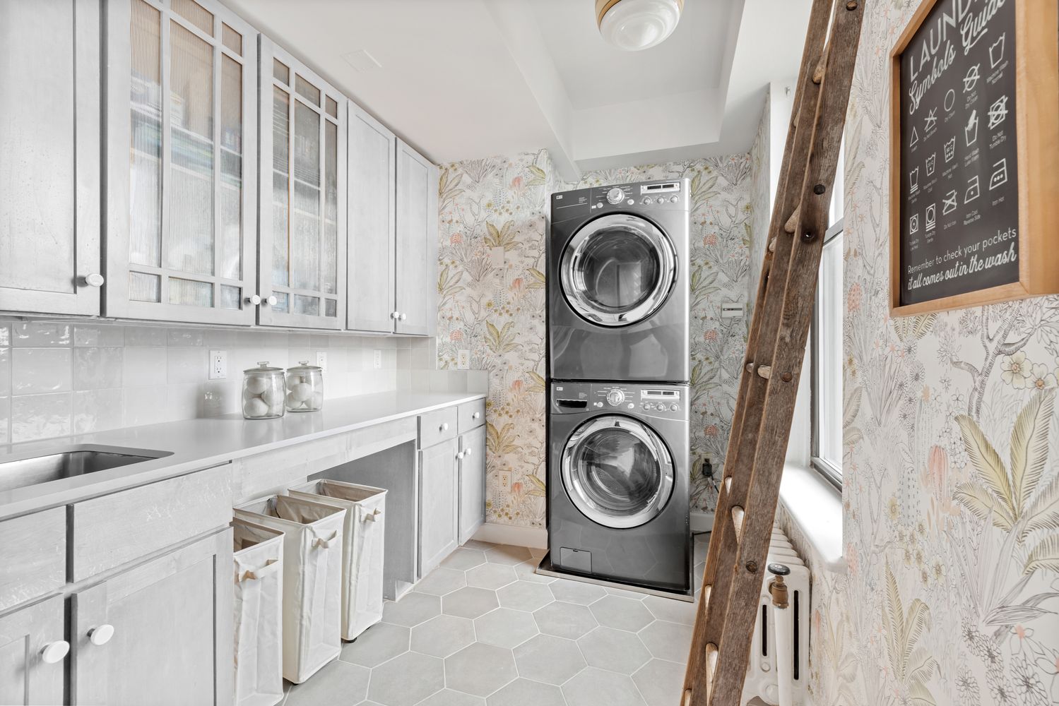 a utility room with sink dryer and washer