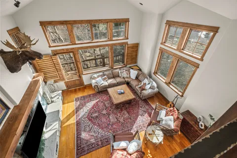 a living room with furniture and a floor to ceiling window