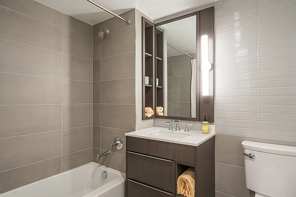 975 Nostrand Avenue, Unit 632 Brooklyn, NY 11225 - Photo 6 of 14 a bathroom with a sink mirror vanity and toilet