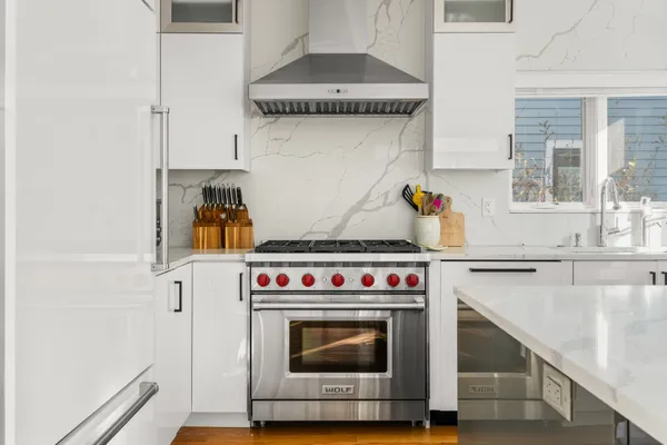 a stove top oven sitting inside of a kitchen