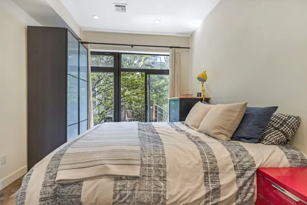 a bedroom with a large bed and a large window