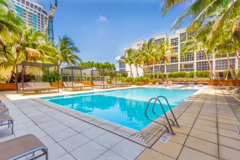 a view of a swimming pool with a lounge chairs