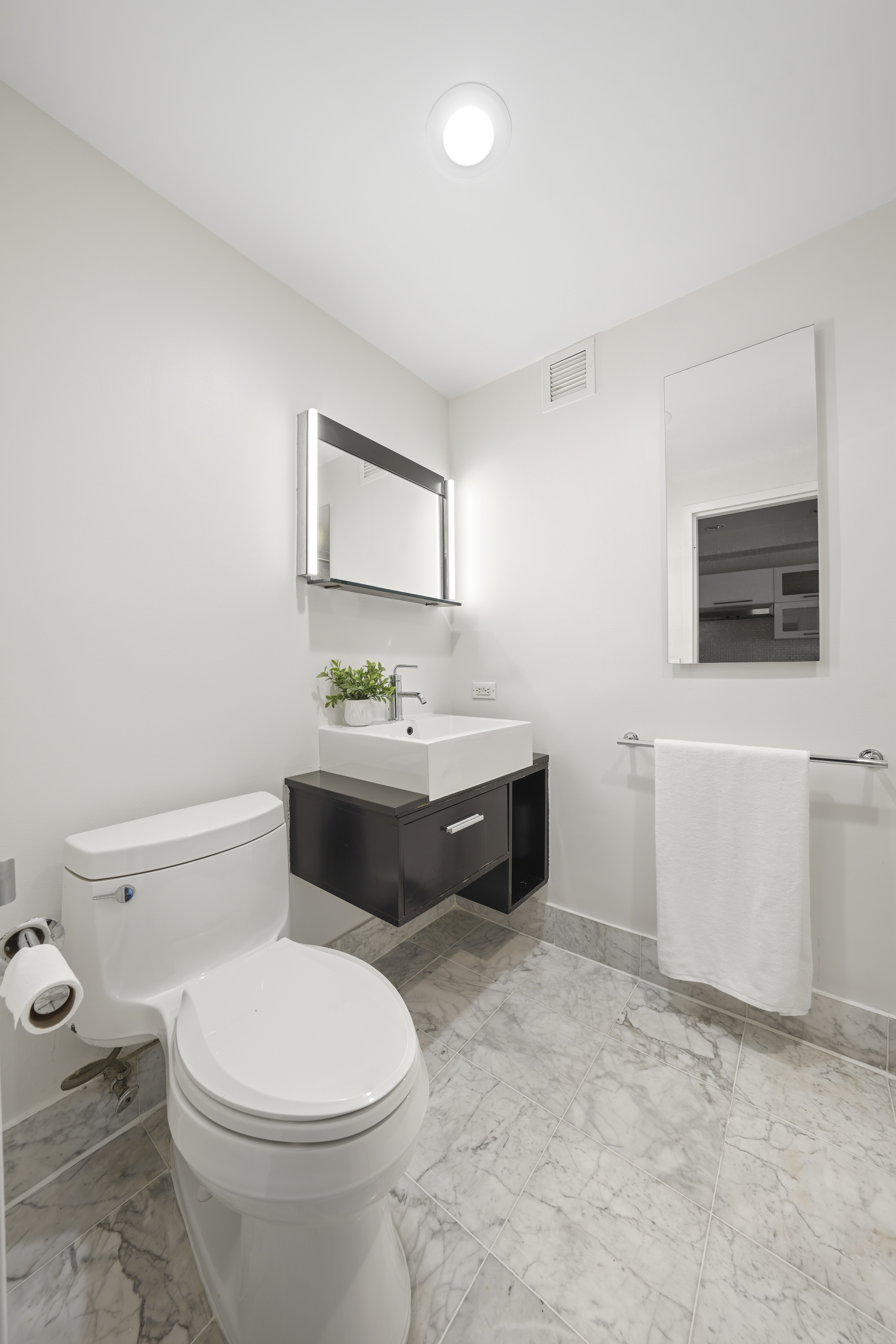 257 West 117th Street, Unit 2F Manhattan, NY 10026 - Photo 14 of 21 a bathroom with a toilet a sink and a mirror
