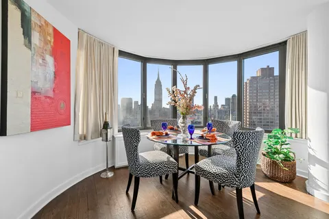 a dining room with furniture and wooden floor