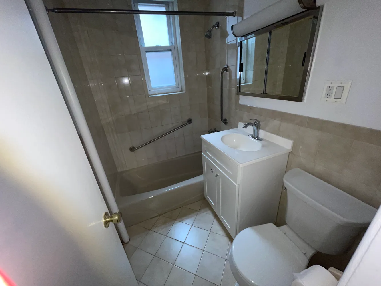 a bathroom with a toilet sink and mirror
