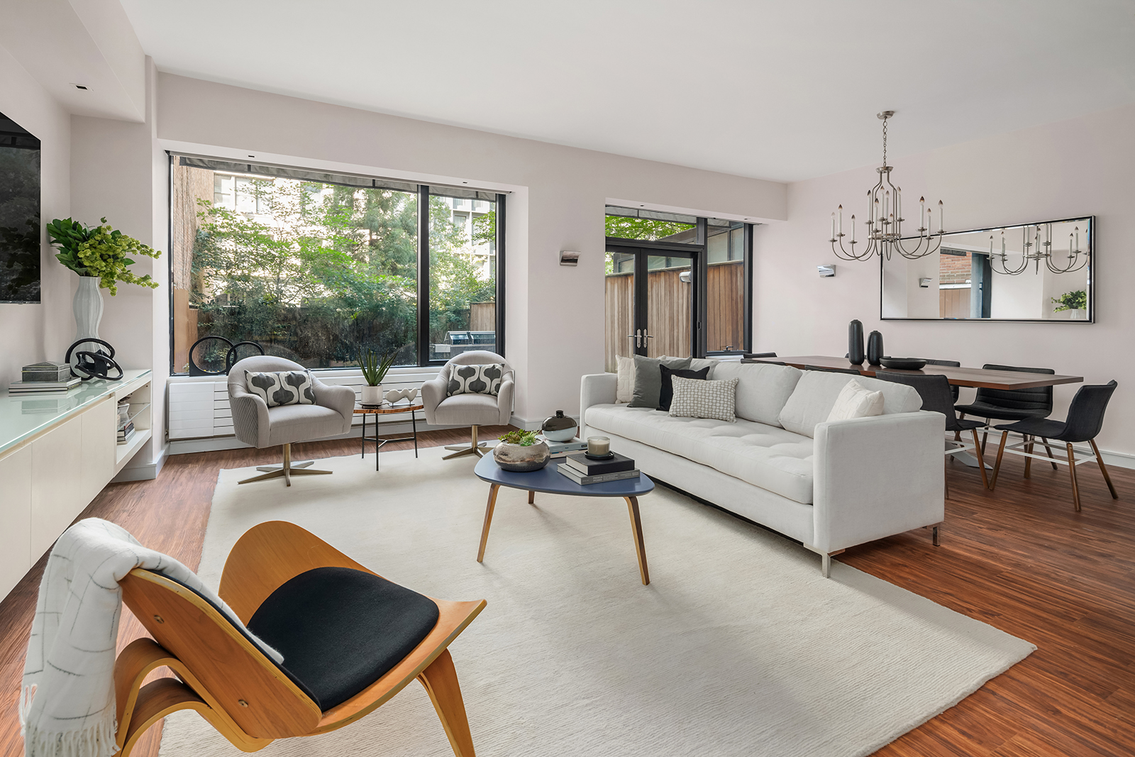 255 Hudson Street, Unit TH1 Manhattan, NY 10013 - Photo 1 of 8 a living room with furniture and a large window