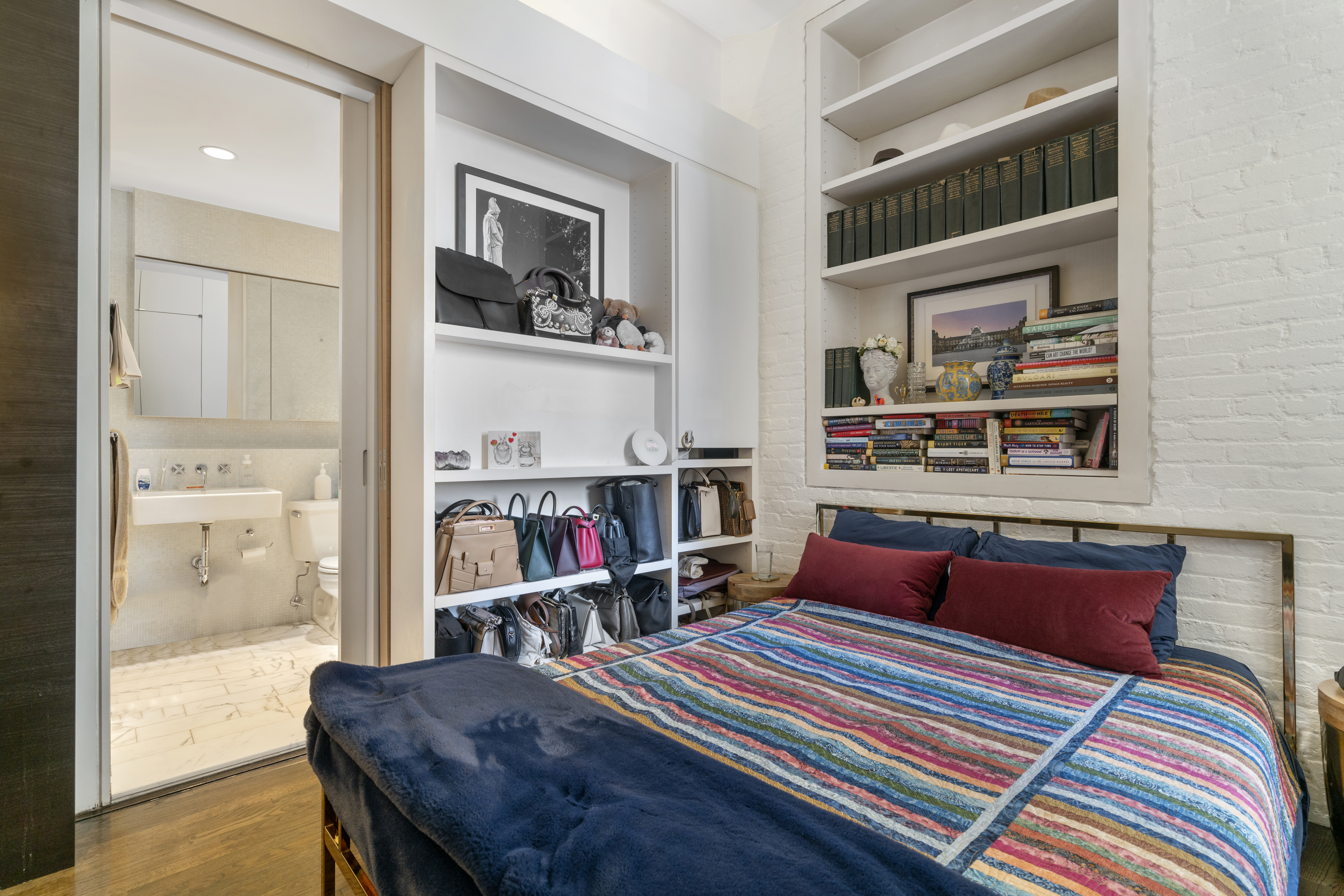 312 East 23rd Street, Unit 7B Manhattan, NY 10010 - Photo 6 of 14 a living room with furniture and a book shelf