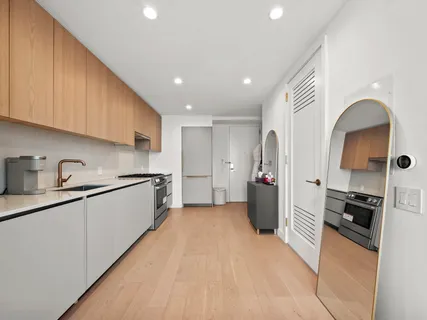 a kitchen with a refrigerator and a sink