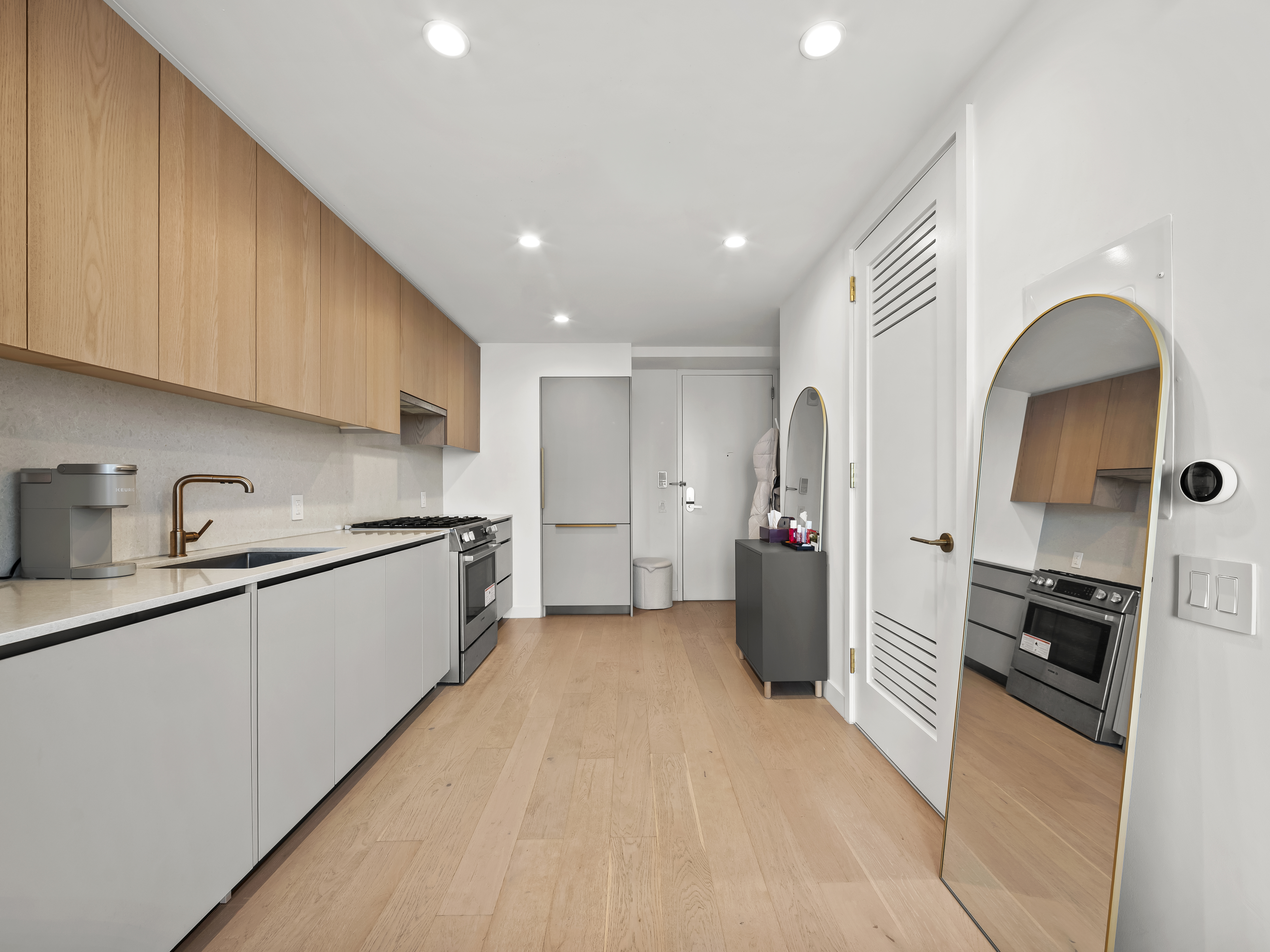 45-3 Court Square, Unit 4406 Queens, NY 11101 - Photo 6 of 22 a kitchen with a refrigerator and a sink