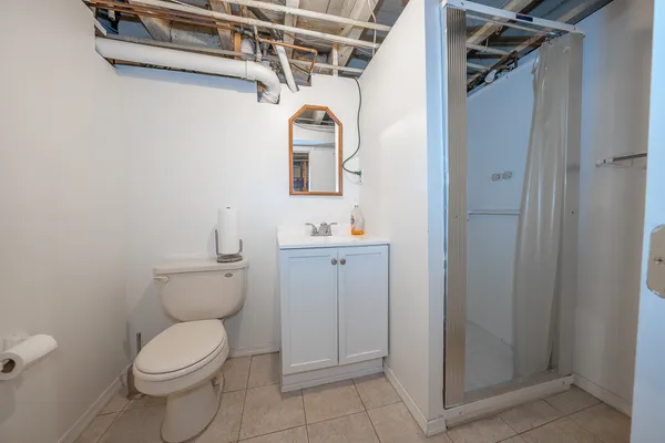 a bathroom with a toilet sink and shower