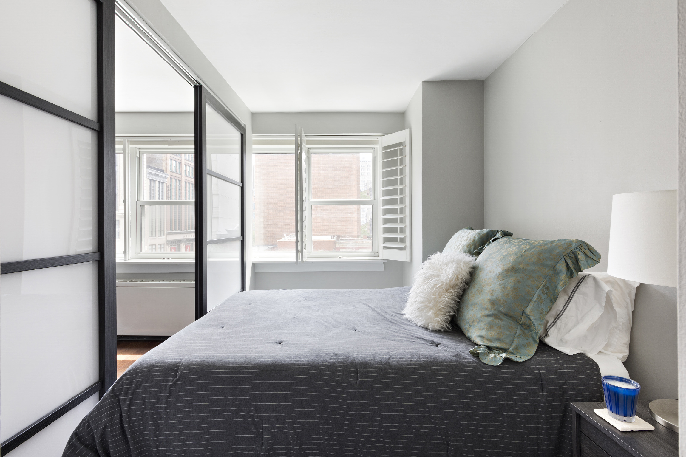 101 West 12th Street, Unit 6L Manhattan, NY 10011 - Photo 8 of 11 a bedroom with a bed and a large window