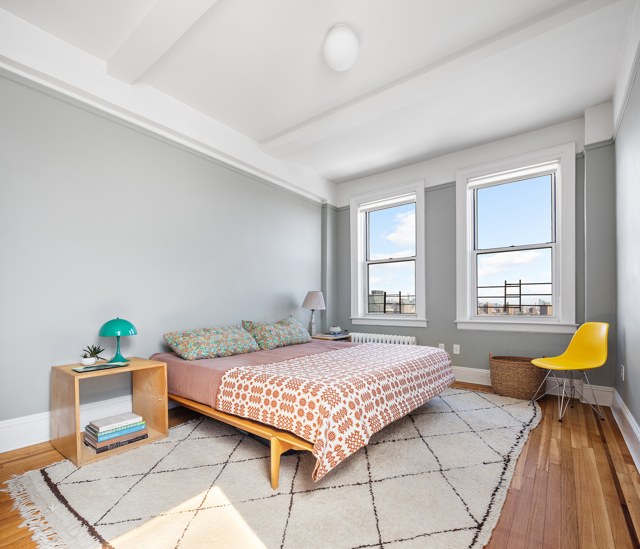 41 Eastern Parkway, Unit 11E Brooklyn, NY 11238 - Photo 7 of 14 a bedroom with a bed and a table in it