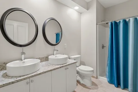 a bathroom with a toilet a sink and a mirror