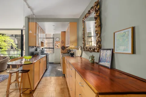 a kitchen with stainless steel appliances granite countertop sink stove and wooden cabinets