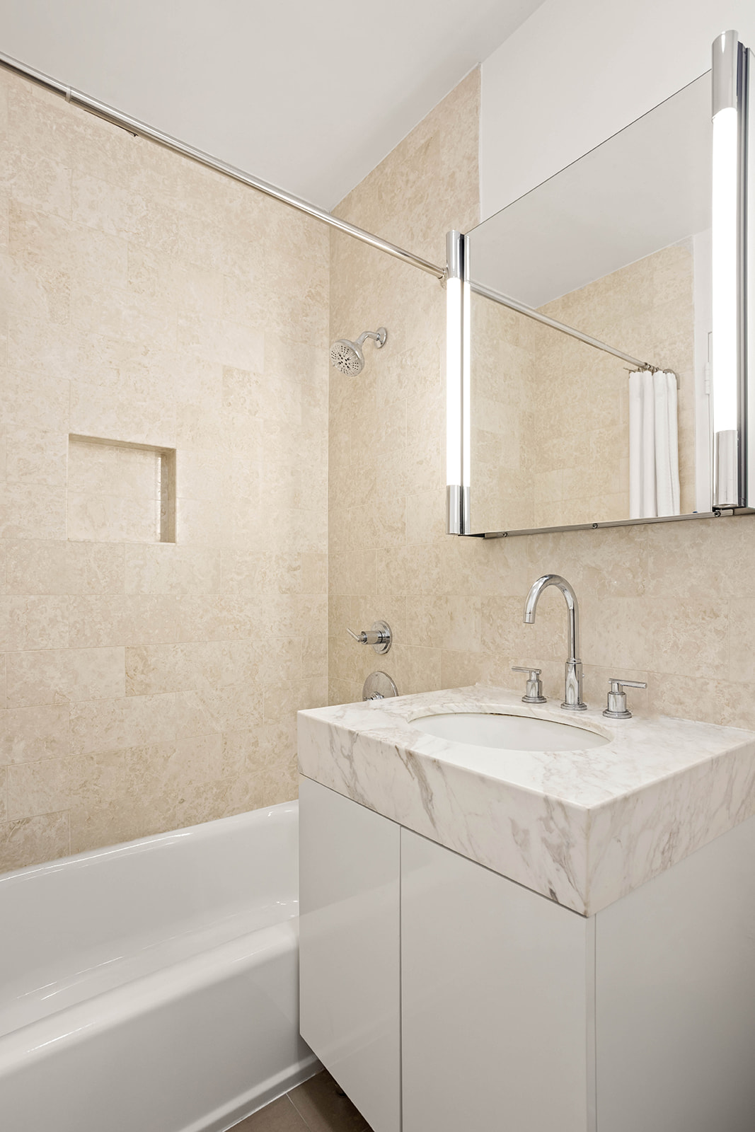 300 East 64th Street, Unit 26B Manhattan, NY 10065 - Photo 16 of 26 a bathroom with a sink and a bathtub