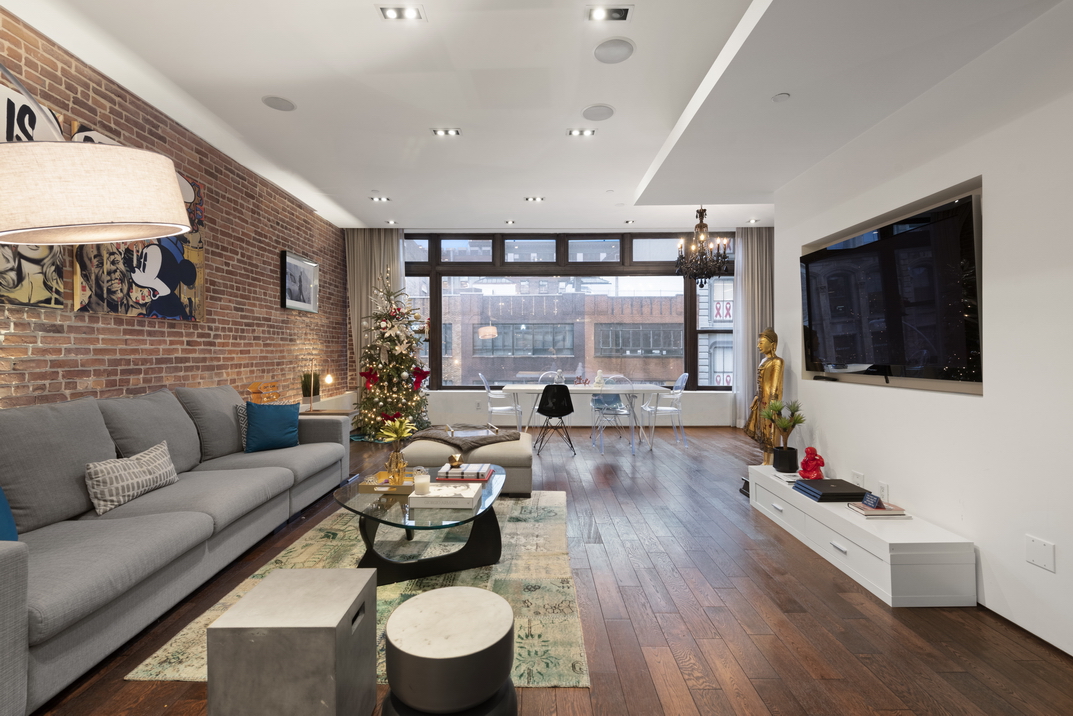 405 Broadway, Unit 3 Manhattan, NY 10013 - Photo 3 of 11 a living room with furniture large window and wooden floor