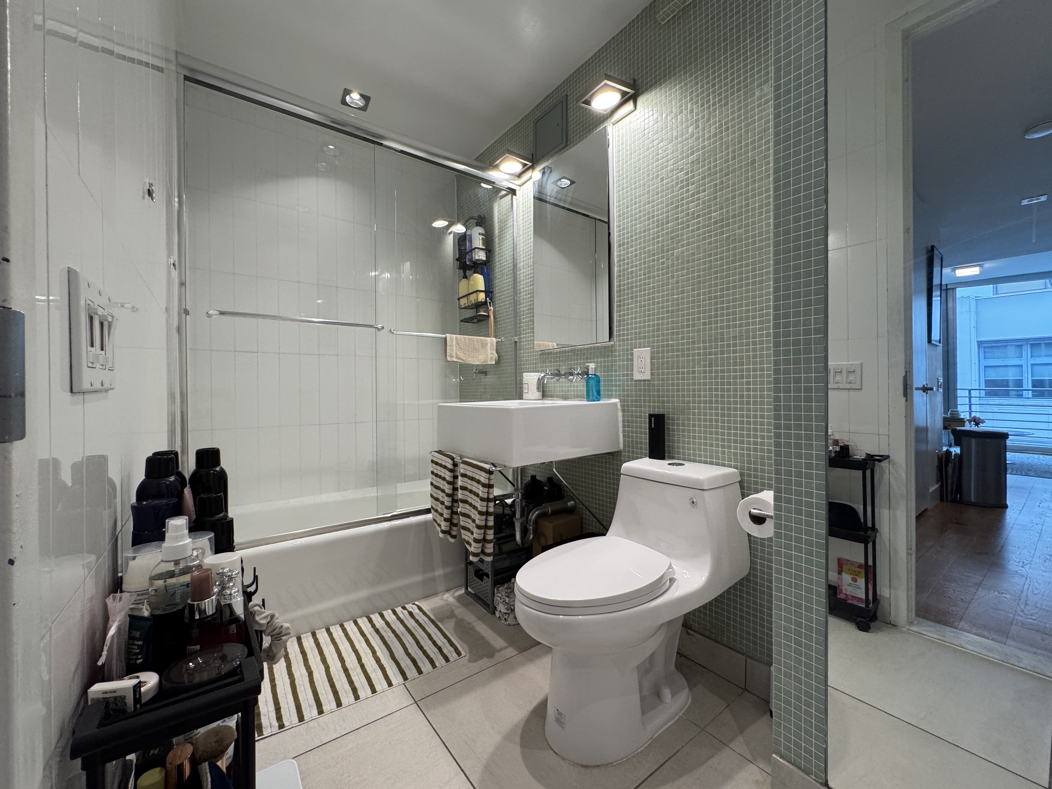 343 West 16th Street, Unit 3F Manhattan, NY 10011 - Photo 9 of 10 a bathroom with a sink toilet and shower