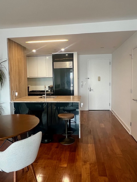 2 Northside Piers, Unit 26C Brooklyn, NY 11249 - Photo 9 of 21 a living room with furniture and a wooden floor