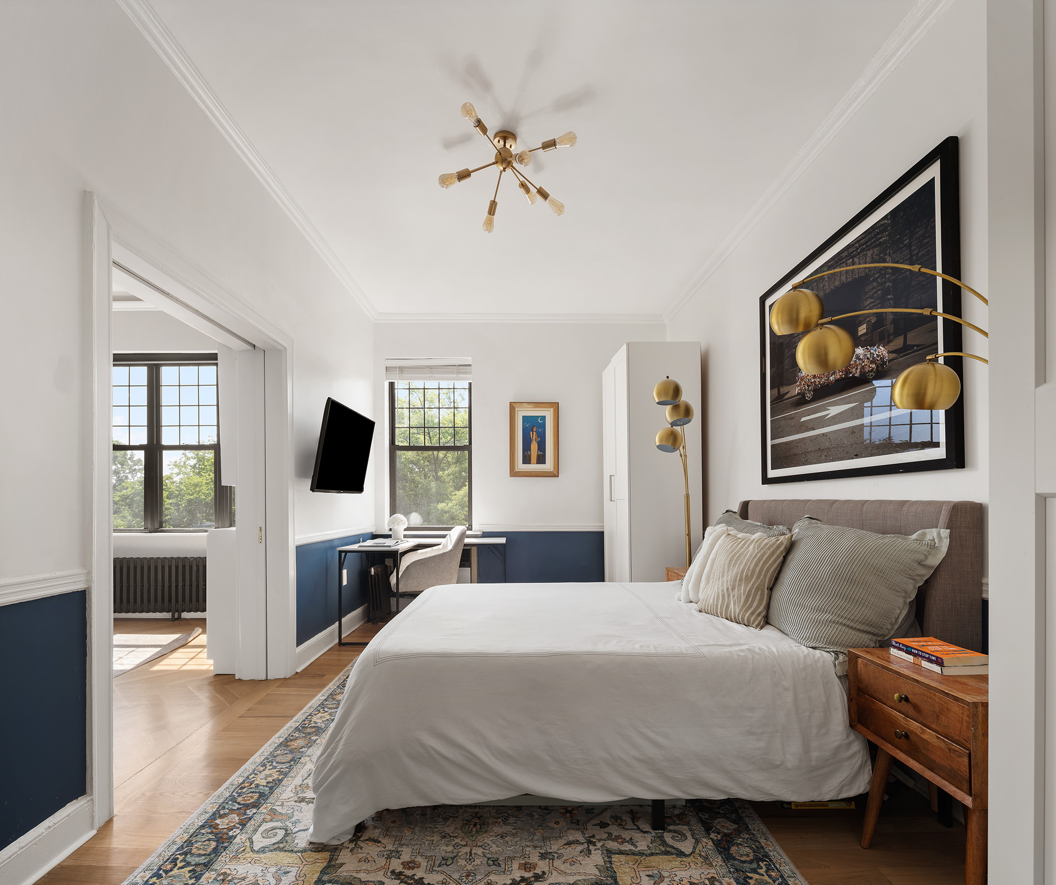 370 Central Park West, Unit PH601 Manhattan, NY 10025 - Photo 12 of 19 a bedroom with a balcony a bed and a chandelier