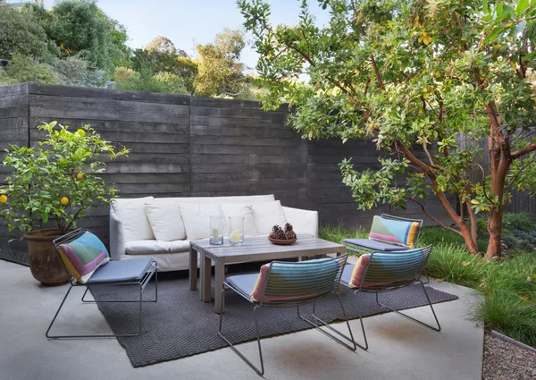 a backyard of a house with table and chairs
