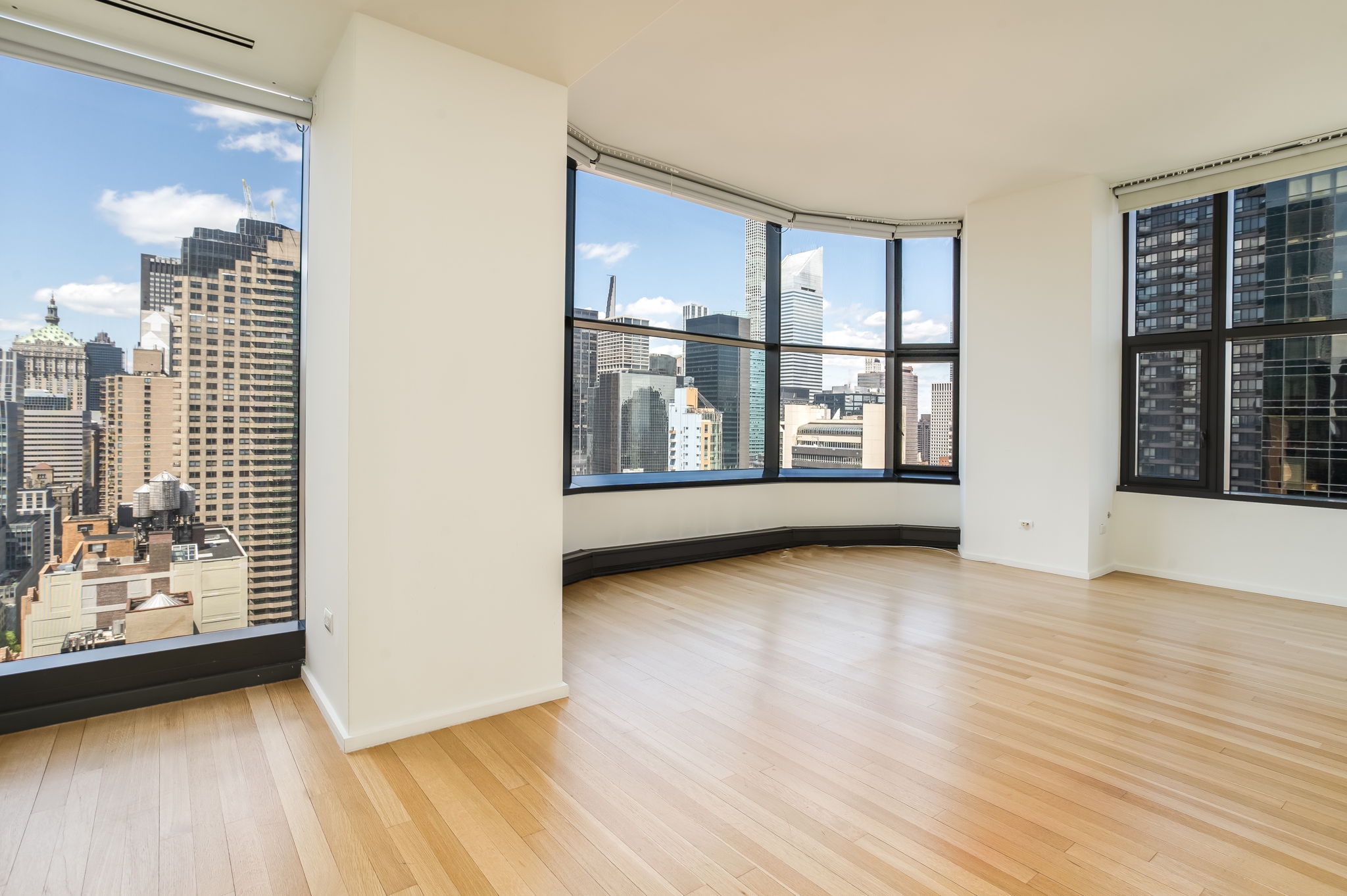 50 United Nations Plaza, Unit 26B Manhattan, NY 10017 - Photo 15 of 25 an empty room with wooden floor and windows