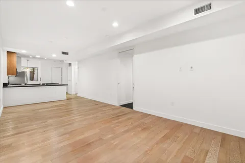 a view of a kitchen with a sink and a refrigerator