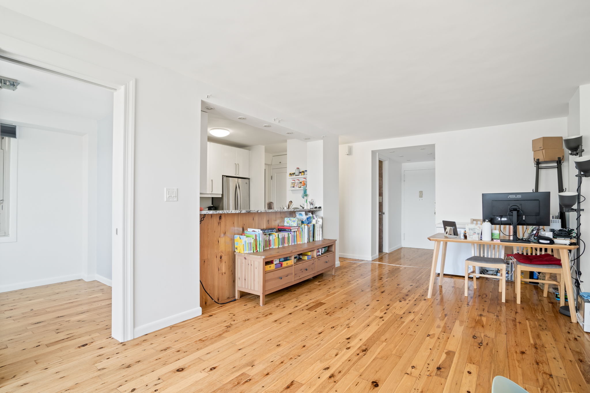900 West 190th Street, Unit 11J Manhattan, NY 10040 - Photo 2 of 15 a living room with furniture and a wooden floor
