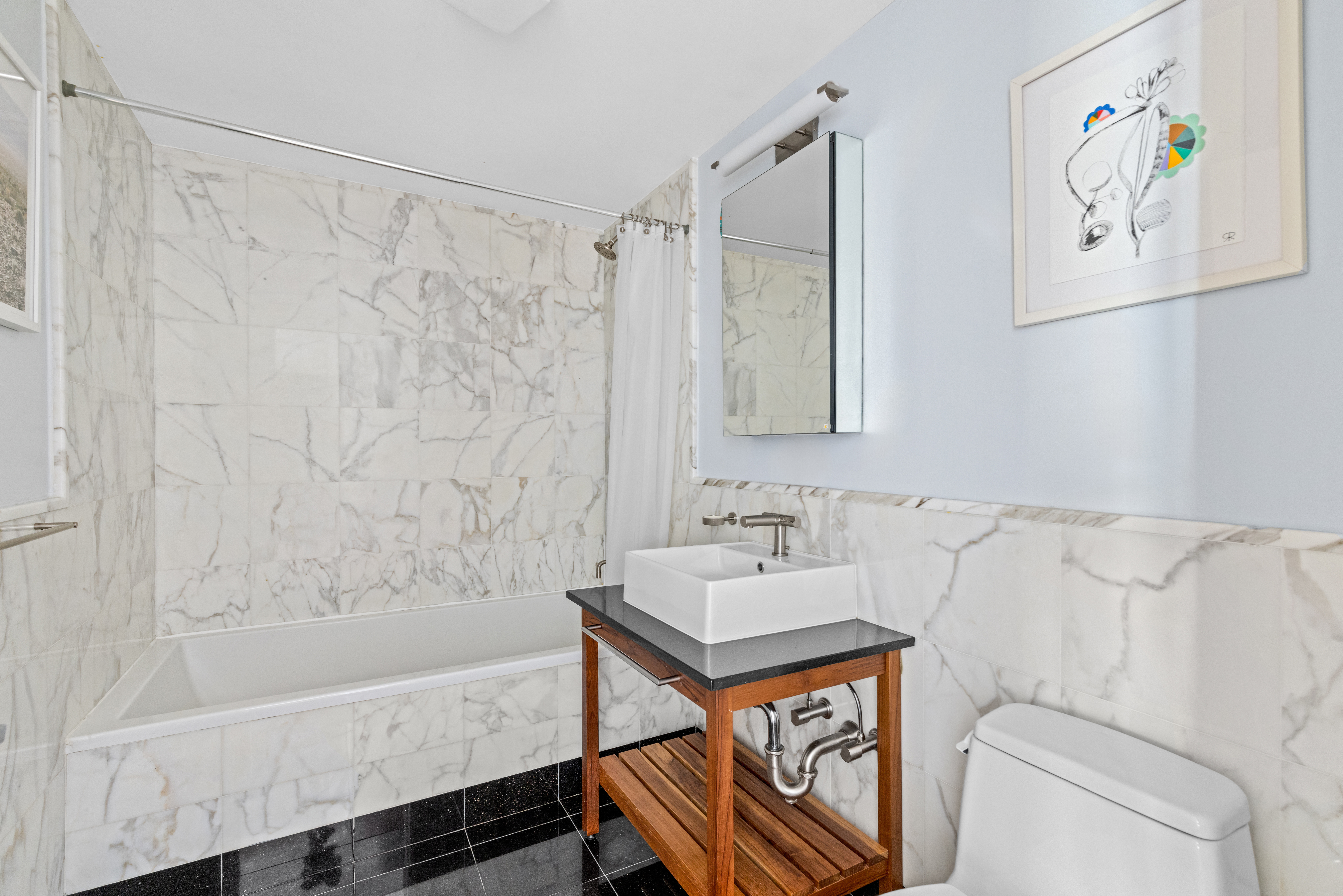 146-148 West 22nd Street, Unit PH Manhattan, NY 10011 - Photo 8 of 12 a bathroom with a sink and a bathtub